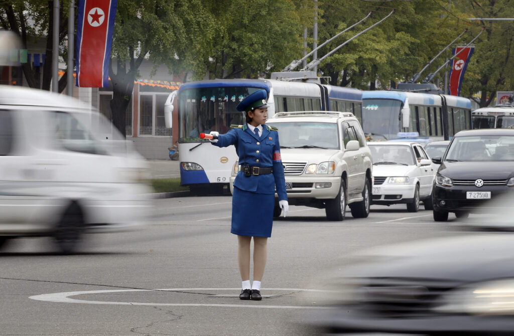 Woman directing traffic in Pyongyang